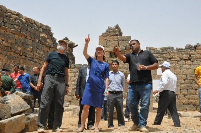 Umm el Jimal workers greet the ambassador and other visitors at the site
